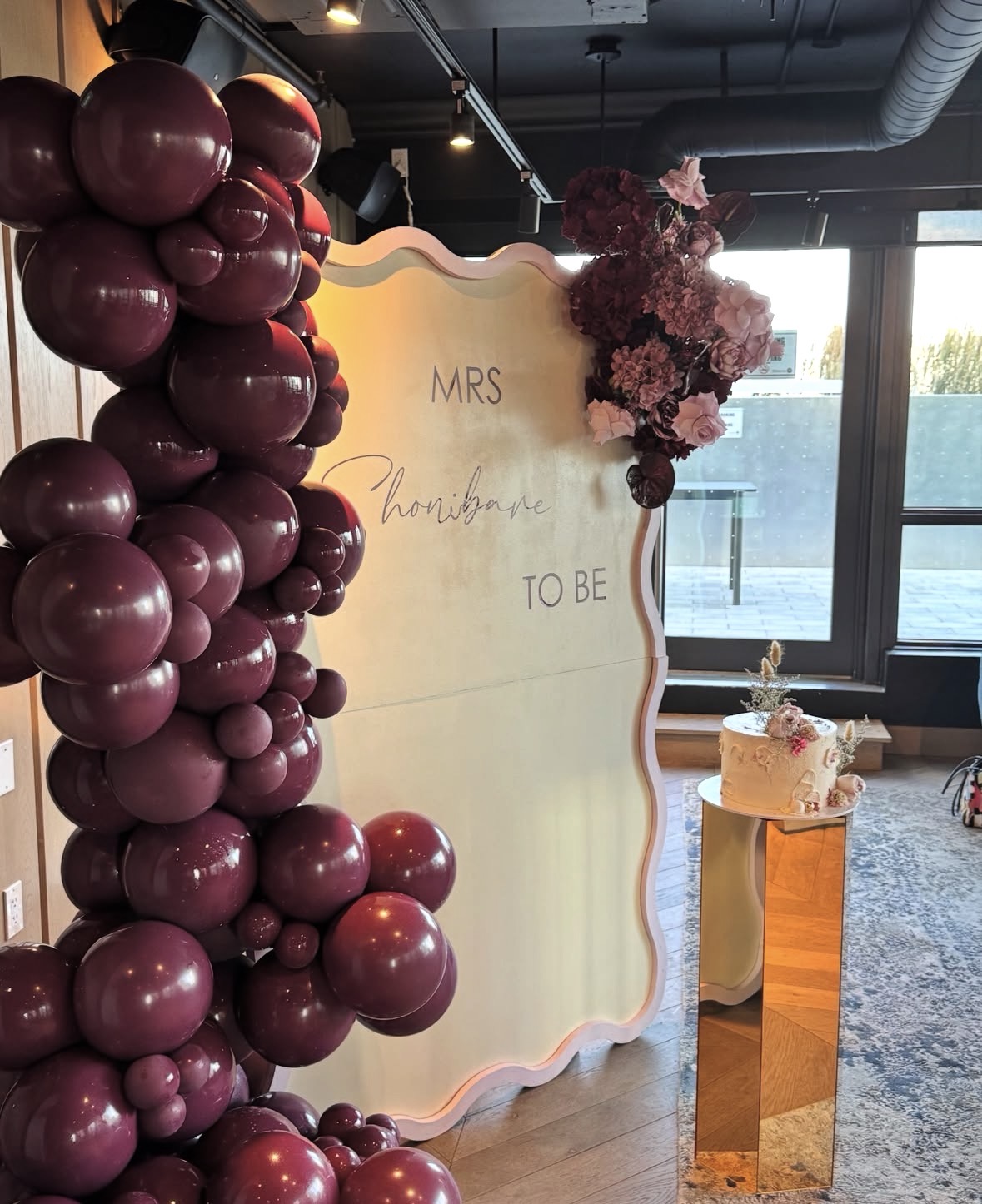 Burgundy balloon and floral installation